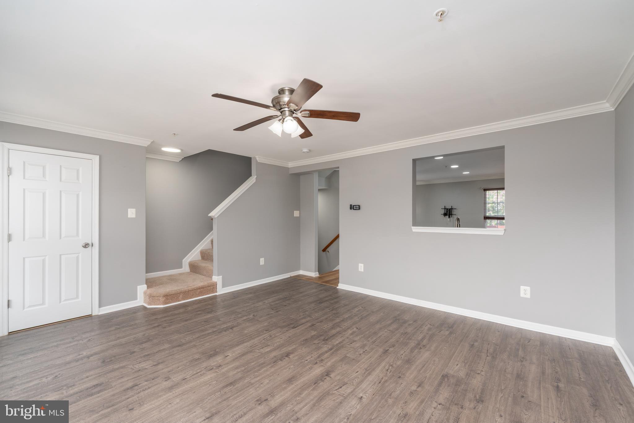 9903 Decatur Road Baltimore, MD 21220 - Photo 19 of 37 an empty room with wooden floor and a ceiling fan