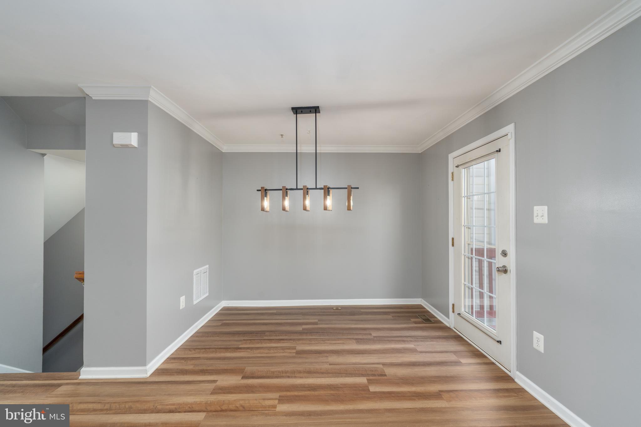 9903 Decatur Road Baltimore, MD 21220 - Photo 20 of 37 a view of an empty room with wooden floor and a window