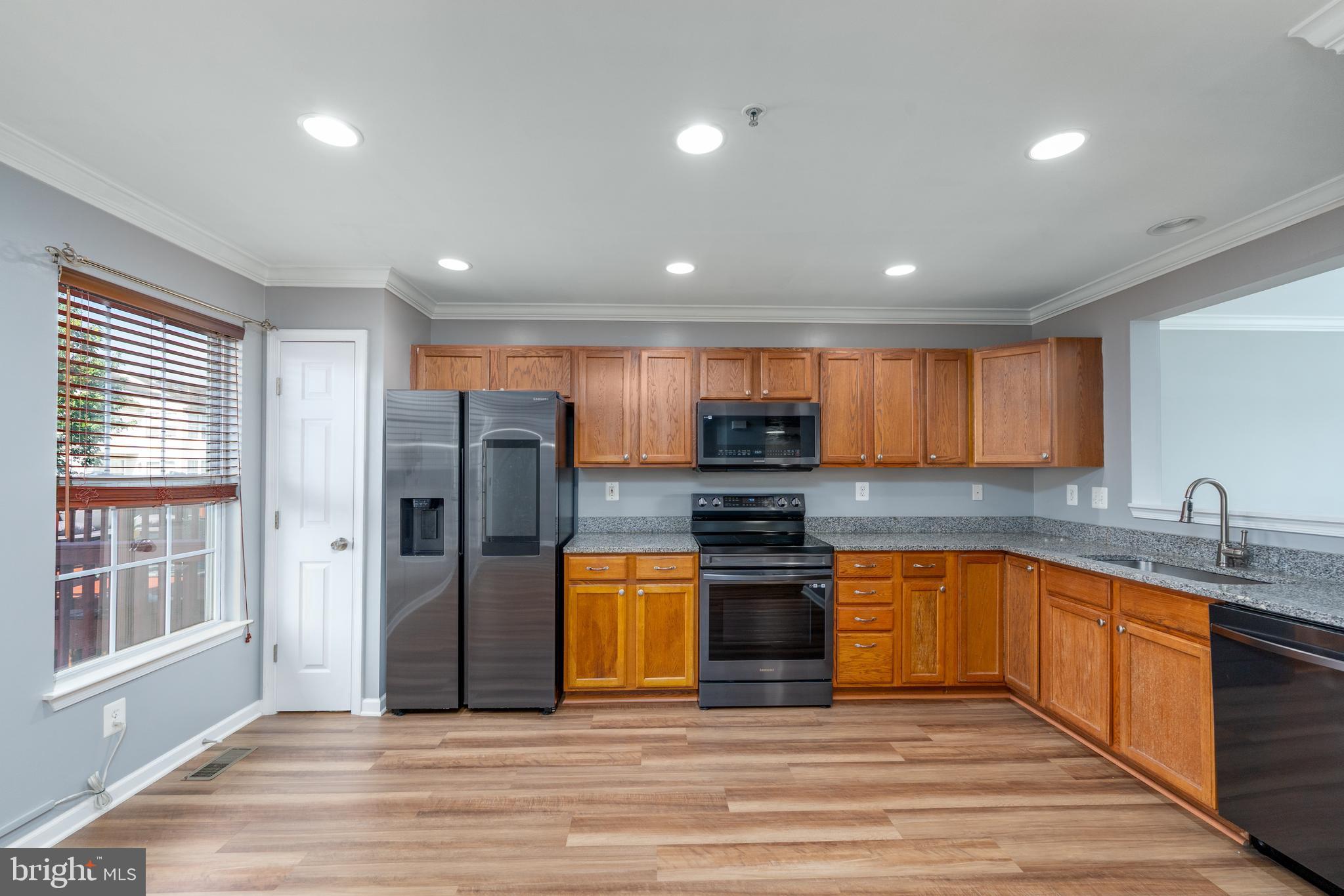 9903 Decatur Road Baltimore, MD 21220 - Photo 21 of 37 a kitchen with stainless steel appliances granite countertop a sink stove and refrigerator