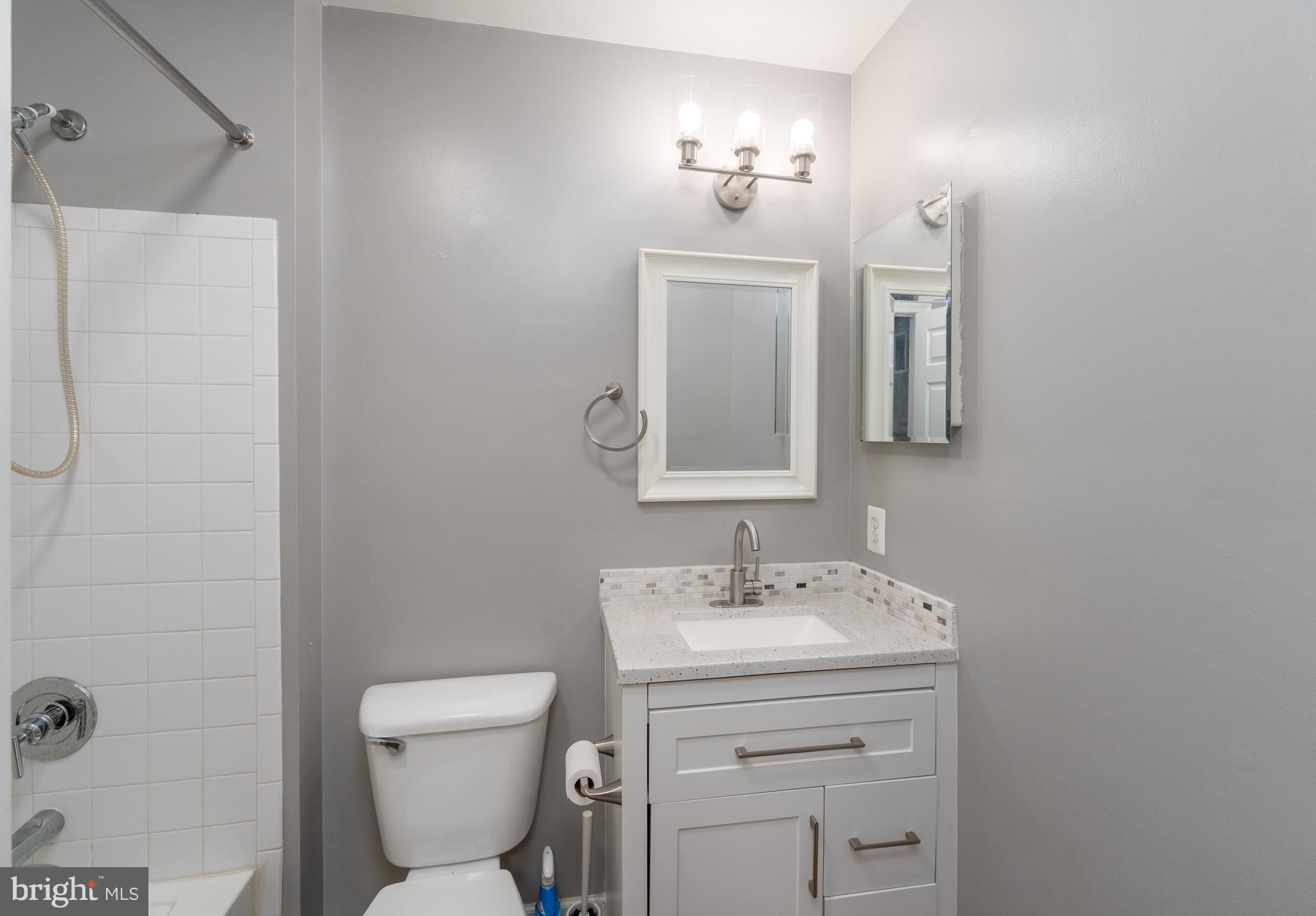 9903 Decatur Road Baltimore, MD 21220 - Photo 23 of 37 a bathroom with a toilet sink and mirror