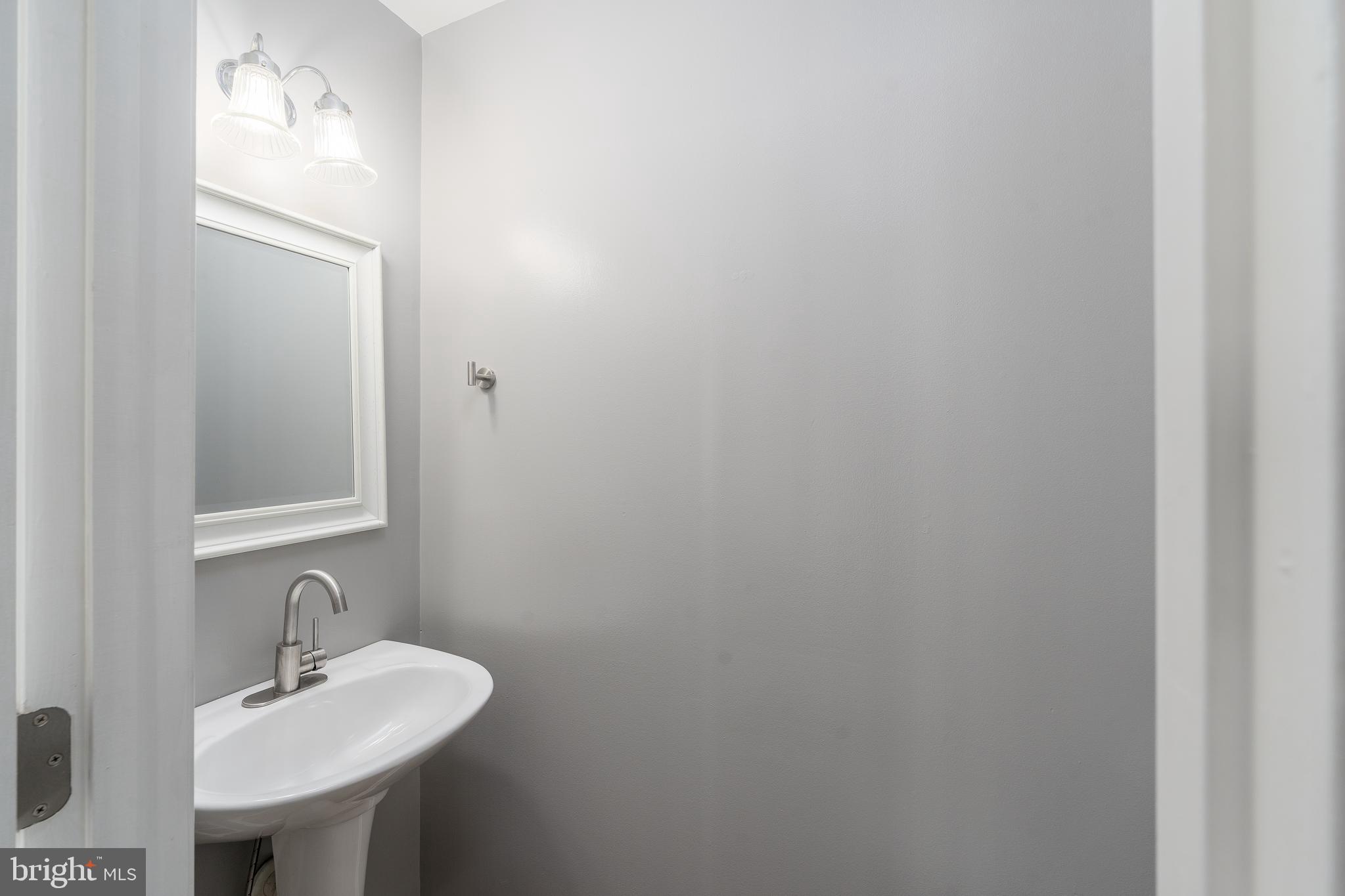 9903 Decatur Road Baltimore, MD 21220 - Photo 4 of 37 a bathroom with a sink and a mirror