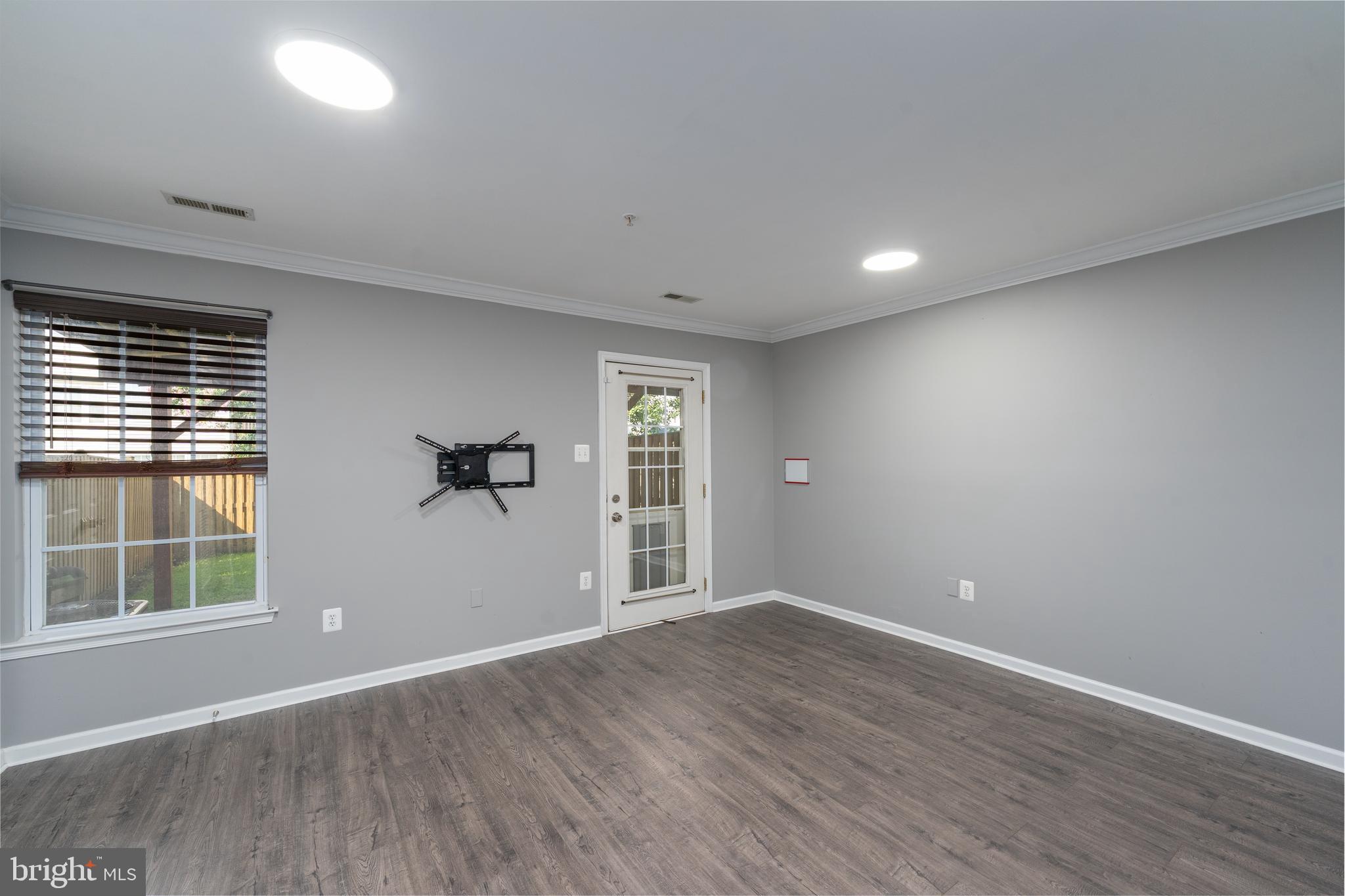 9903 Decatur Road Baltimore, MD 21220 - Photo 9 of 37 a view of empty room with wooden floor and fan