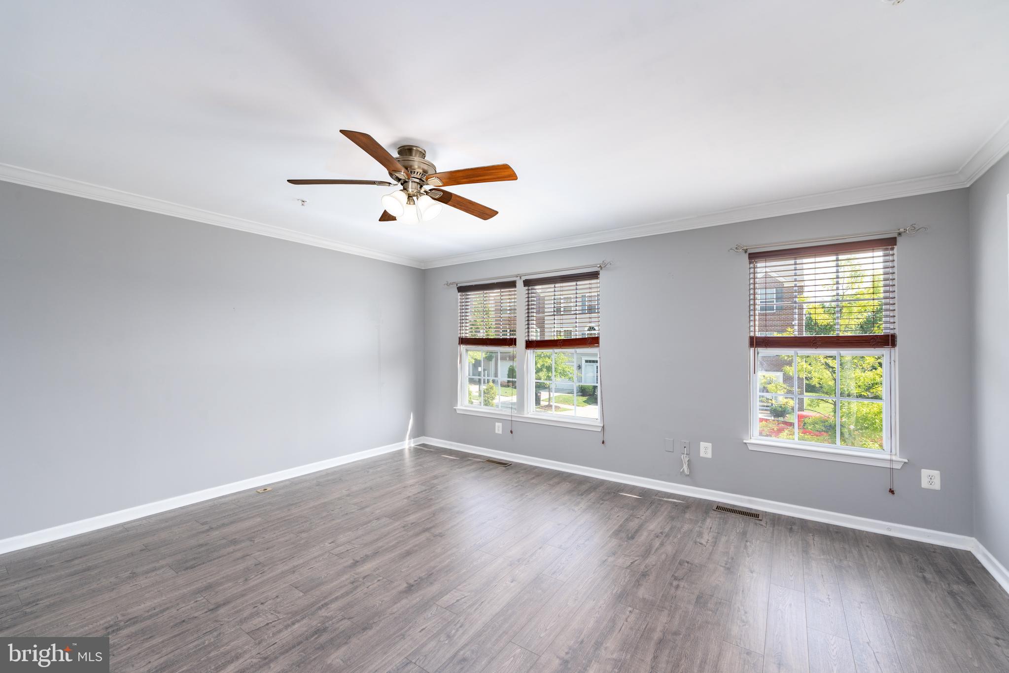 9903 Decatur Road Baltimore, MD 21220 - Photo 10 of 37 an empty room with wooden floor and windows