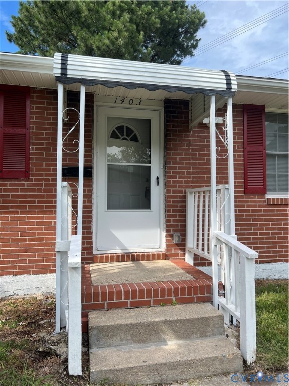 1403 Algona Road Chesapeake, VA 23324 - Photo 2 of 39 Brick exterior featuring a white entry door with a