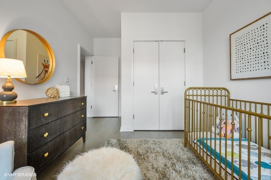 1400 West Monroe Street, Unit 5F Chicago, IL 60607 - Photo 19 of 25 a bedroom with a bed and a dresser