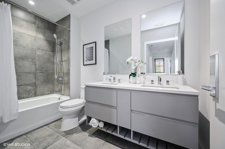 1400 West Monroe Street, Unit 5F Chicago, IL 60607 - Photo 22 of 25 a bathroom with a double vanity sink mirror and toilet
