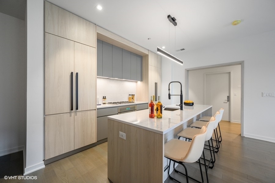 1400 West Monroe Street, Unit 5F Chicago, IL 60607 - Photo 6 of 25 a kitchen with refrigerator and cabinets