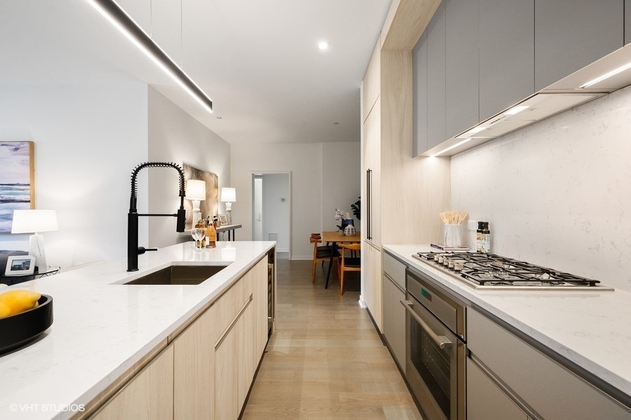 1400 West Monroe Street, Unit 5F Chicago, IL 60607 - Photo 7 of 25 a kitchen with sink stove and cabinets
