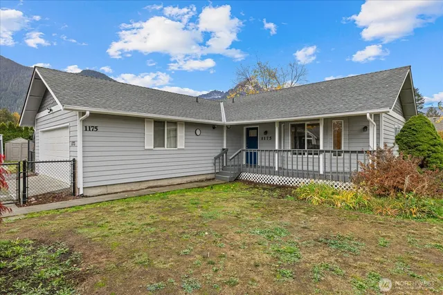 a backyard of a house with table and chairs