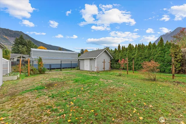 a backyard of a house with table and chairs