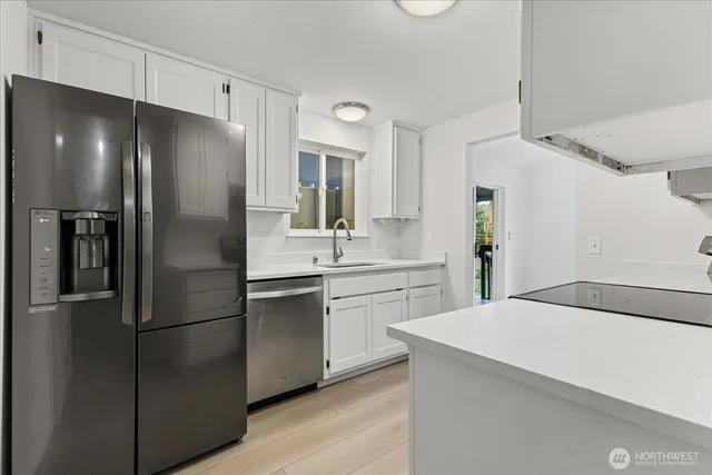 a kitchen with a refrigerator and a sink
