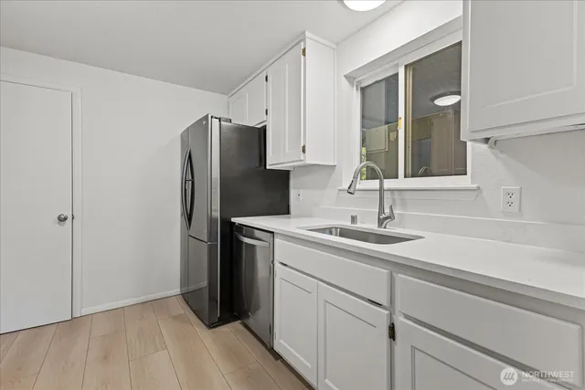 a kitchen with a sink and refrigerator