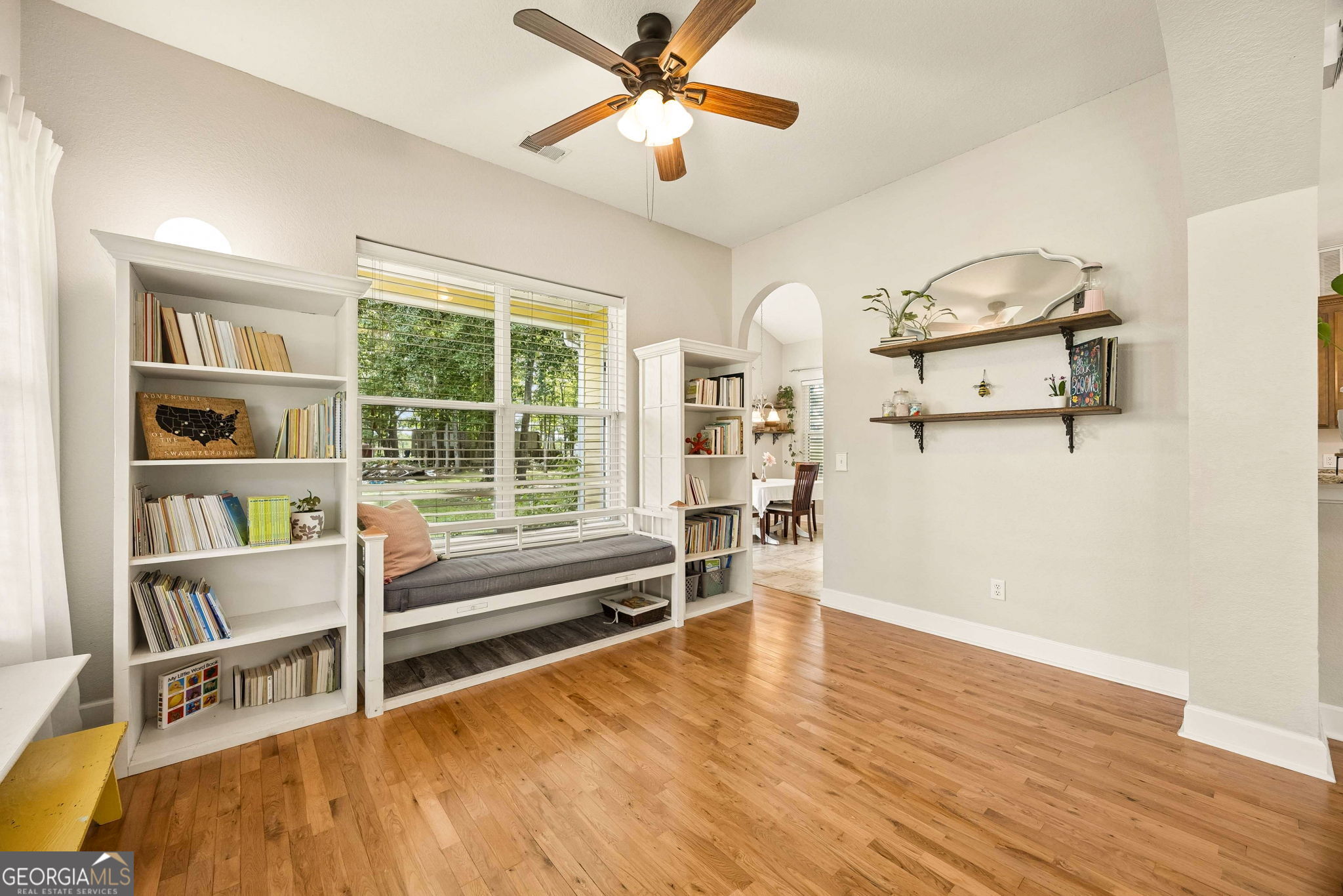 706 Hopewell Point Road White Oak, GA 31568 - Photo 11 of 84 Framed by custom built-in bookcases and large windows overlooking the property, this charming reading nook creates a cozy retreat filled with natural light.