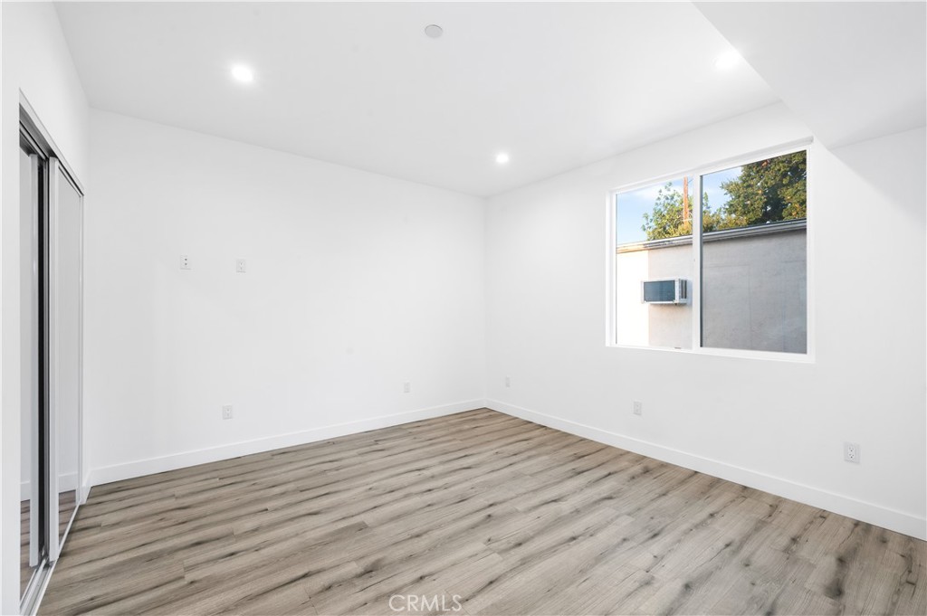 5000 Cleon Avenue, Unit 1/2 North Hollywood, CA 91601 - Photo 16 of 36 an empty room with wooden floor and windows