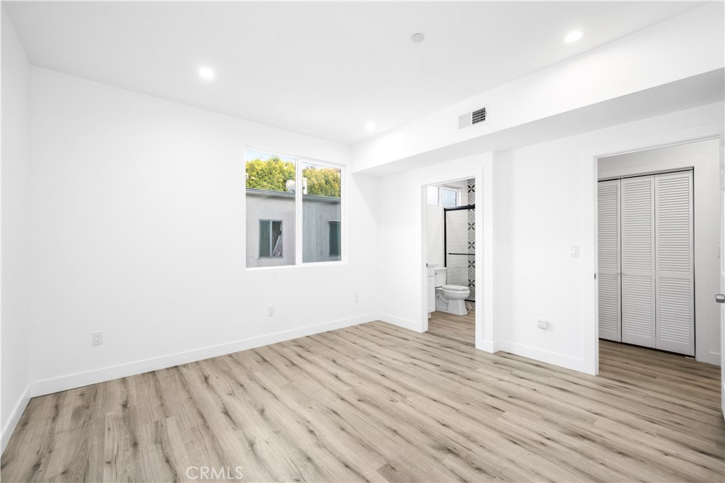 5000 Cleon Avenue, Unit 1/2 North Hollywood, CA 91601 - Photo 17 of 36 an empty room with wooden floor and windows