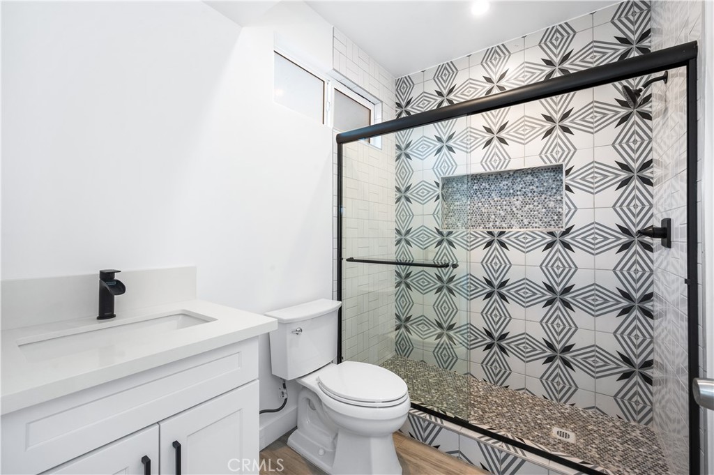 5000 Cleon Avenue, Unit 1/2 North Hollywood, CA 91601 - Photo 19 of 36 a bathroom with a toilet and a shower curtain