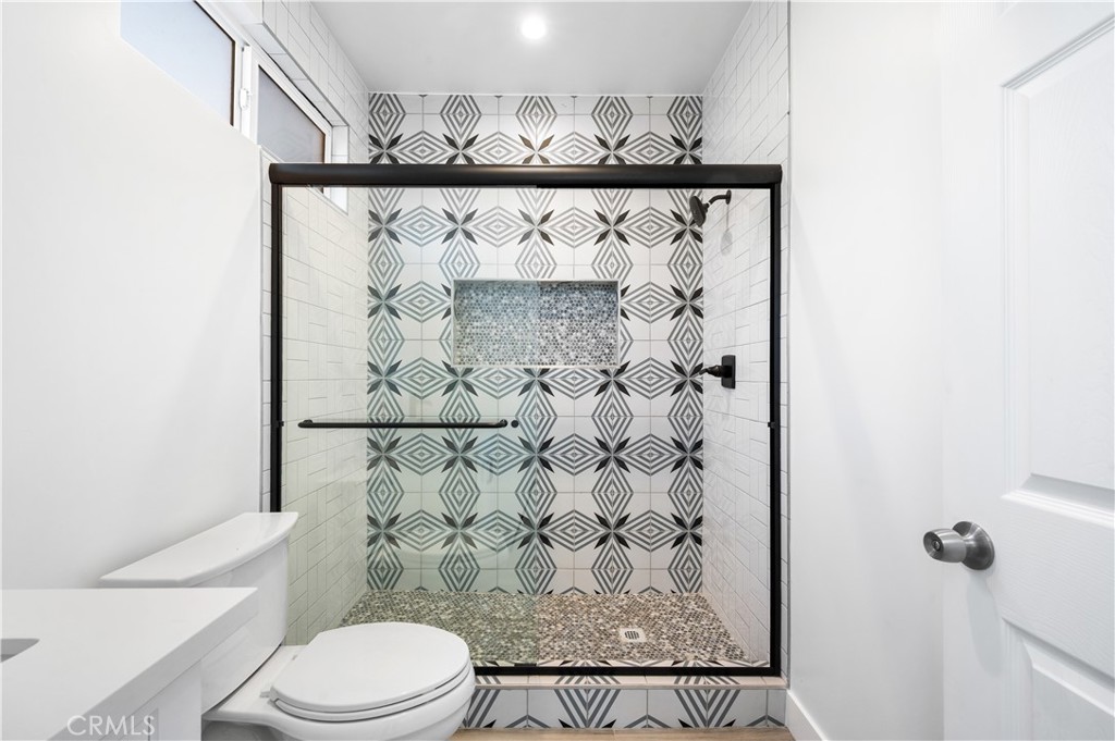 5000 Cleon Avenue, Unit 1/2 North Hollywood, CA 91601 - Photo 20 of 36 a bathroom with a toilet and a shower curtain