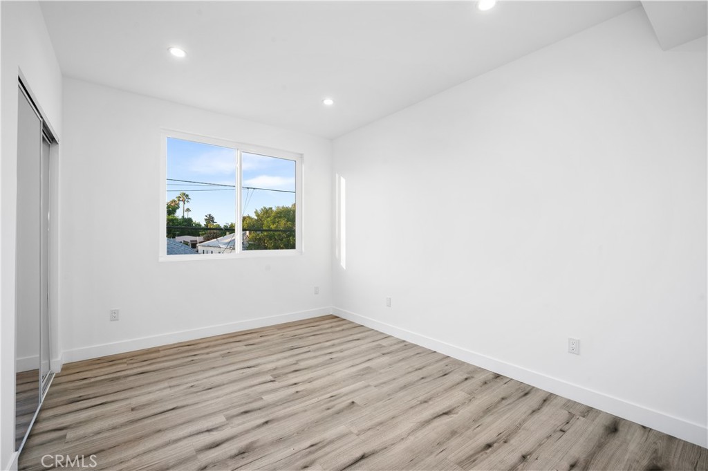 5000 Cleon Avenue, Unit 1/2 North Hollywood, CA 91601 - Photo 21 of 36 an empty room with wooden floor and windows