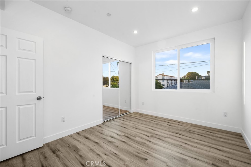 5000 Cleon Avenue, Unit 1/2 North Hollywood, CA 91601 - Photo 22 of 36 a view of an empty room with window and wooden floor