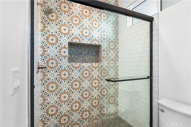 a bathroom with a shower and a toilet