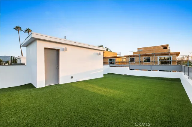 a backyard with a table and chairs a barbeque