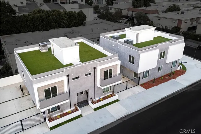 a aerial view of a house with roof deck and furniture