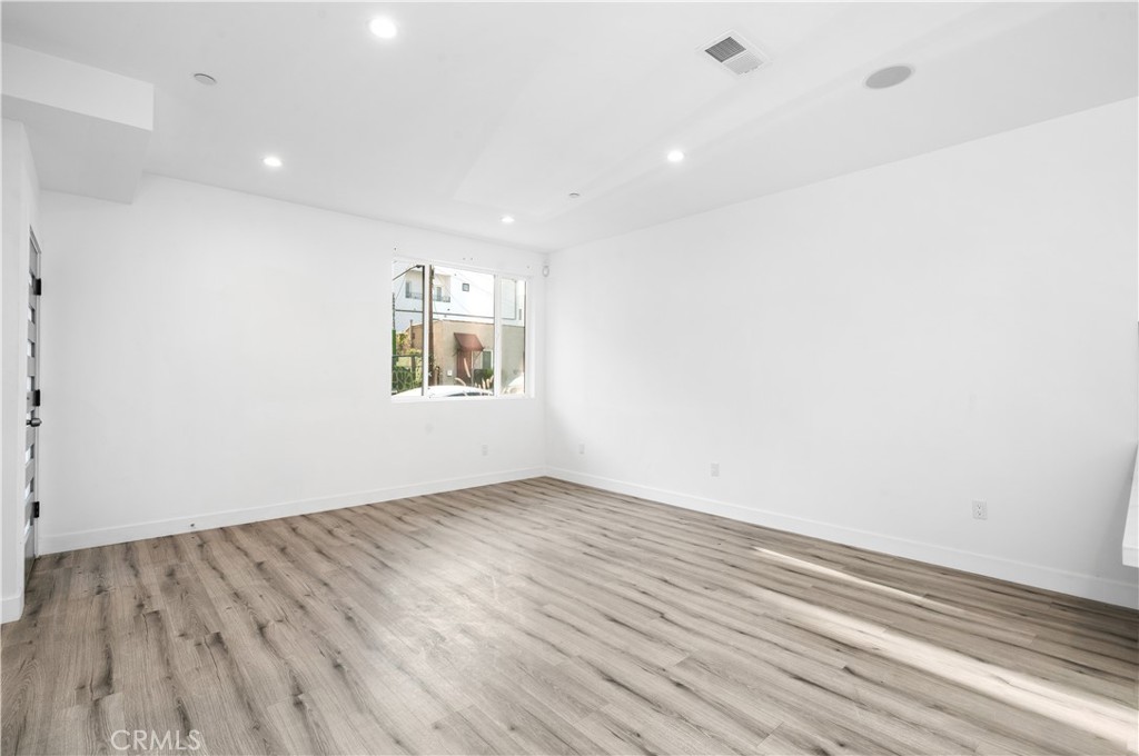 5000 Cleon Avenue, Unit 1/2 North Hollywood, CA 91601 - Photo 5 of 36 an empty room with wooden floor and windows