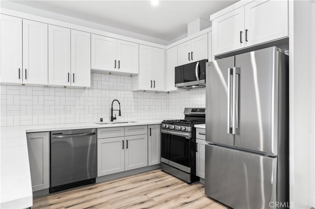 5000 Cleon Avenue, Unit 1/2 North Hollywood, CA 91601 - Photo 8 of 36 a kitchen with stainless steel appliances a refrigerator stove and sink