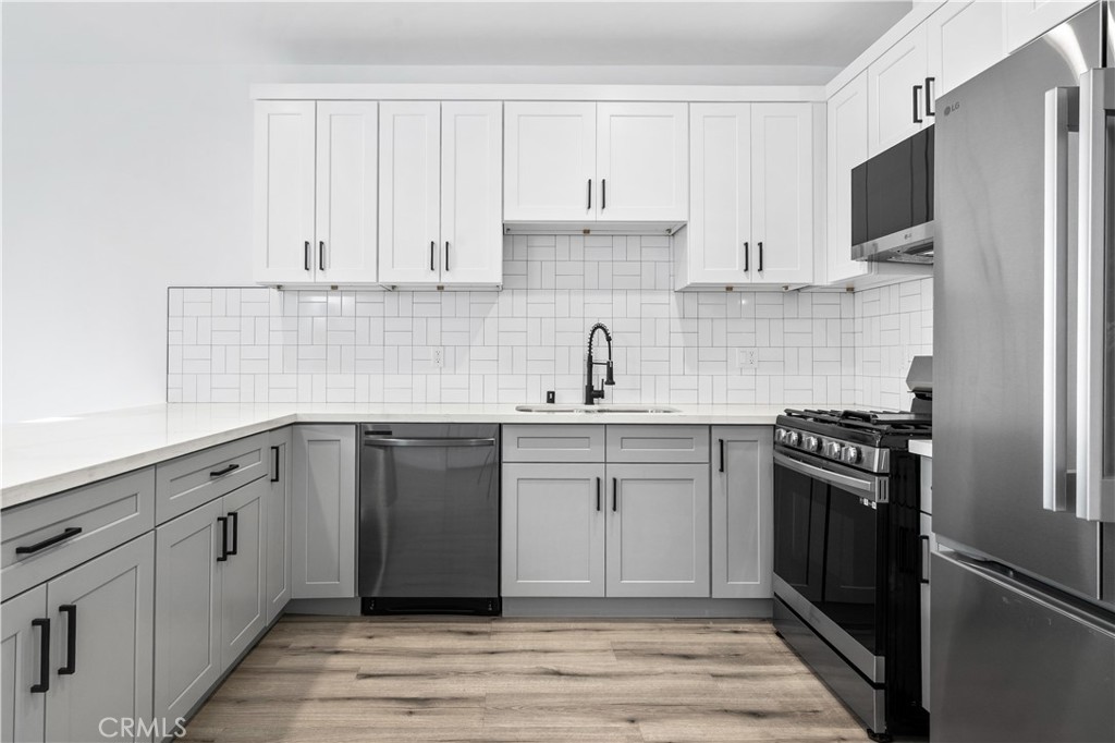 5000 Cleon Avenue, Unit 1/2 North Hollywood, CA 91601 - Photo 9 of 36 a kitchen with cabinets stainless steel appliances and sink