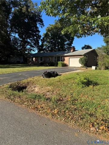 a view of a house with a yard and tree