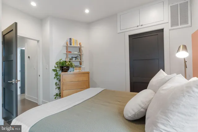 a bedroom with a bed and a dresser