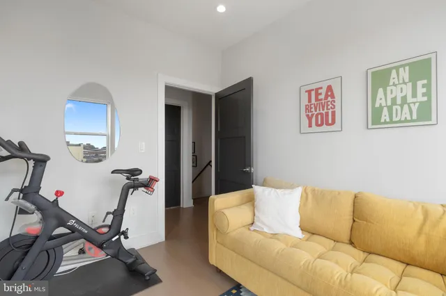 a living room with furniture a flat screen tv and a window