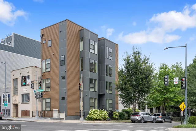 a city street lined with buildings and trees