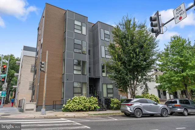 a couple of cars parked in front of brick building