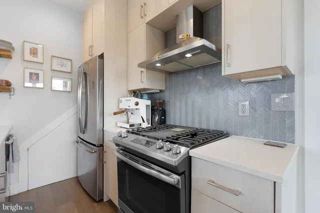 a kitchen with stainless steel appliances granite countertop a stove and a refrigerator