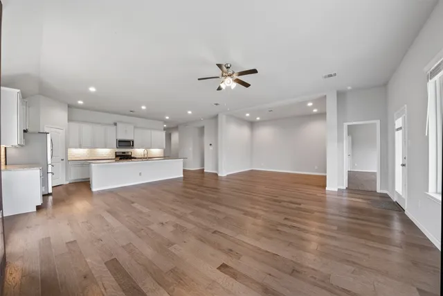a view of kitchen with kitchen island wooden floor and center island