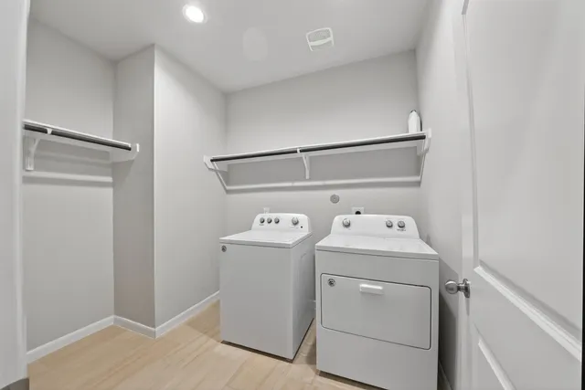 a view of washer and dryer with wooden floor