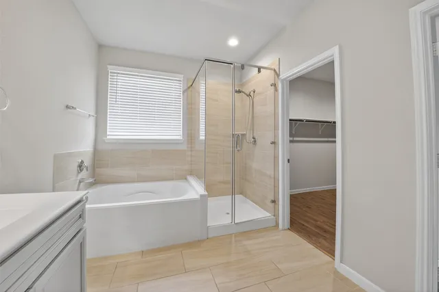 a bathroom with a bathtub and a shower