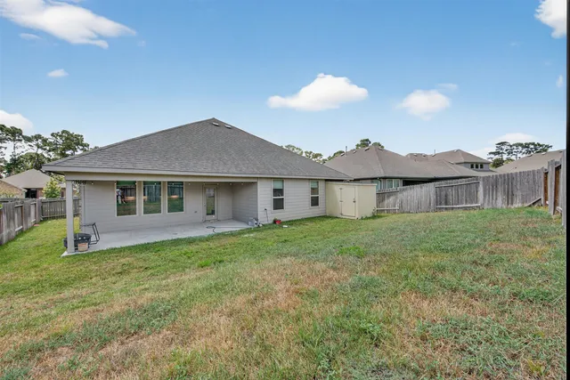 a view of an house with backyard space and garden
