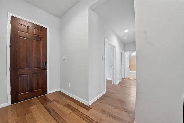 a view of a hallway with wooden floor