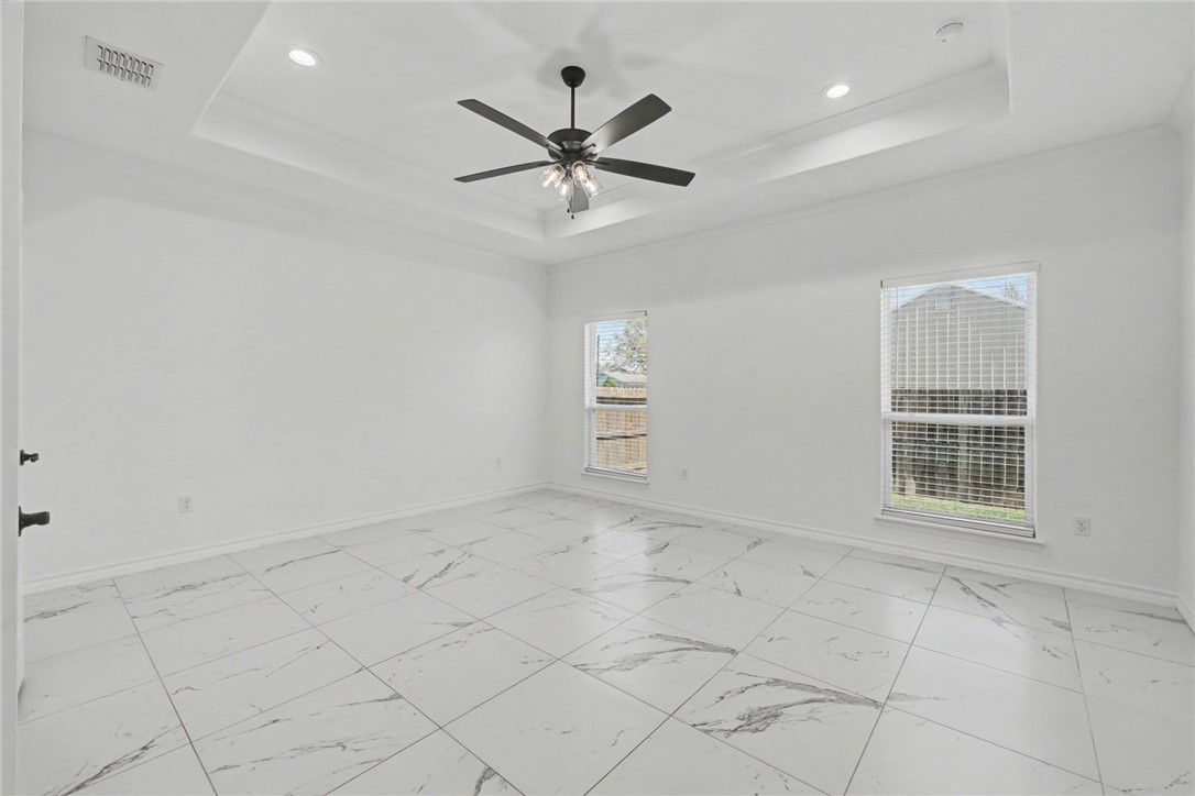 118 Amethyst Street Portland, TX 78374 - Photo 11 of 39 an empty room with windows and ceiling fan
