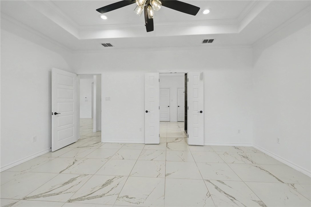 118 Amethyst Street Portland, TX 78374 - Photo 12 of 39 an empty room with white walls and ceiling fan