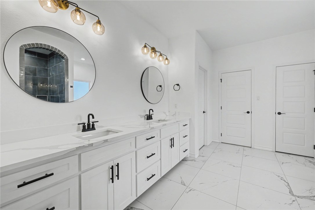 118 Amethyst Street Portland, TX 78374 - Photo 14 of 39 a spacious bathroom with double sink and a mirror