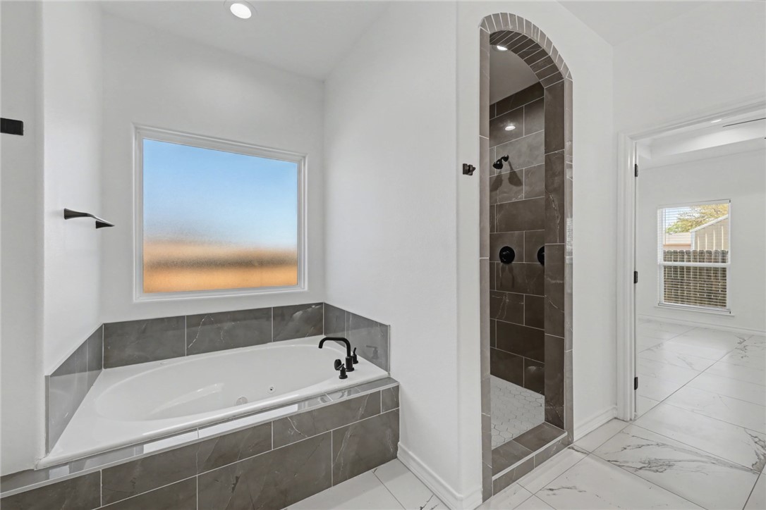 118 Amethyst Street Portland, TX 78374 - Photo 15 of 39 a bathroom with a tub and shower