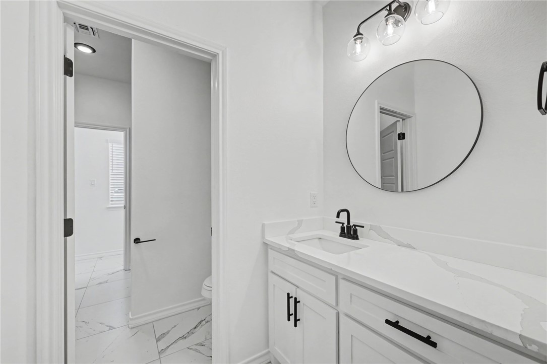 118 Amethyst Street Portland, TX 78374 - Photo 24 of 39 a bathroom with a sink and a mirror
