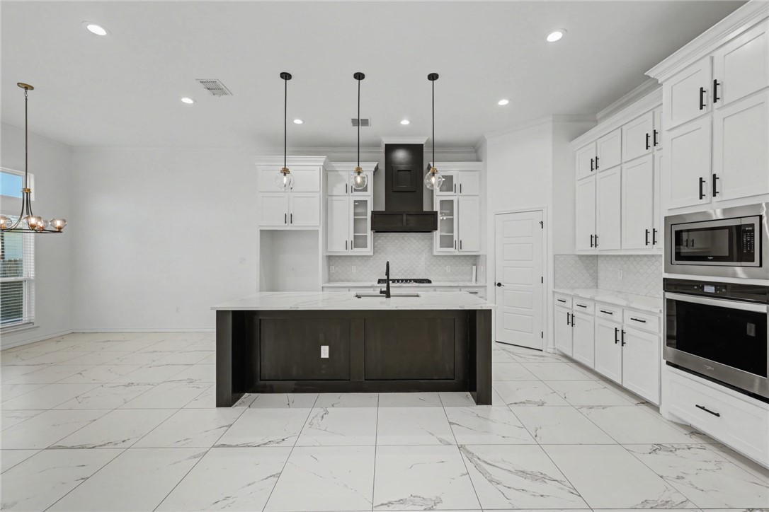 118 Amethyst Street Portland, TX 78374 - Photo 6 of 39 a view of kitchen with stainless steel appliances kitchen island granite countertop a stove a sink and a refrigerator