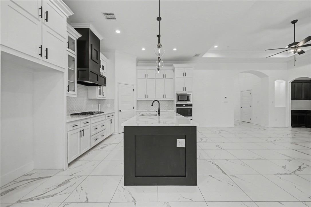 118 Amethyst Street Portland, TX 78374 - Photo 8 of 39 a kitchen with stainless steel appliances granite countertop a sink and a stove