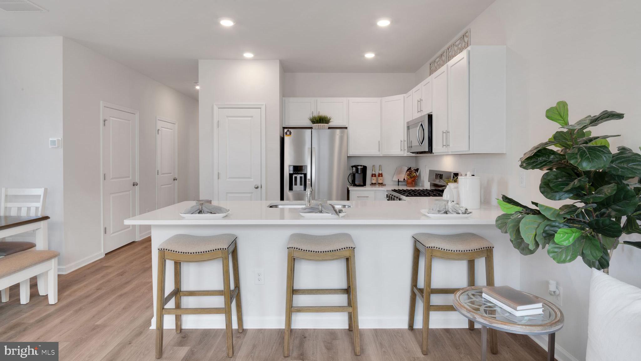 4 Whaler Drive Runnemede, NJ 08078 - Photo 17 of 24 a kitchen with white cabinets and chairs