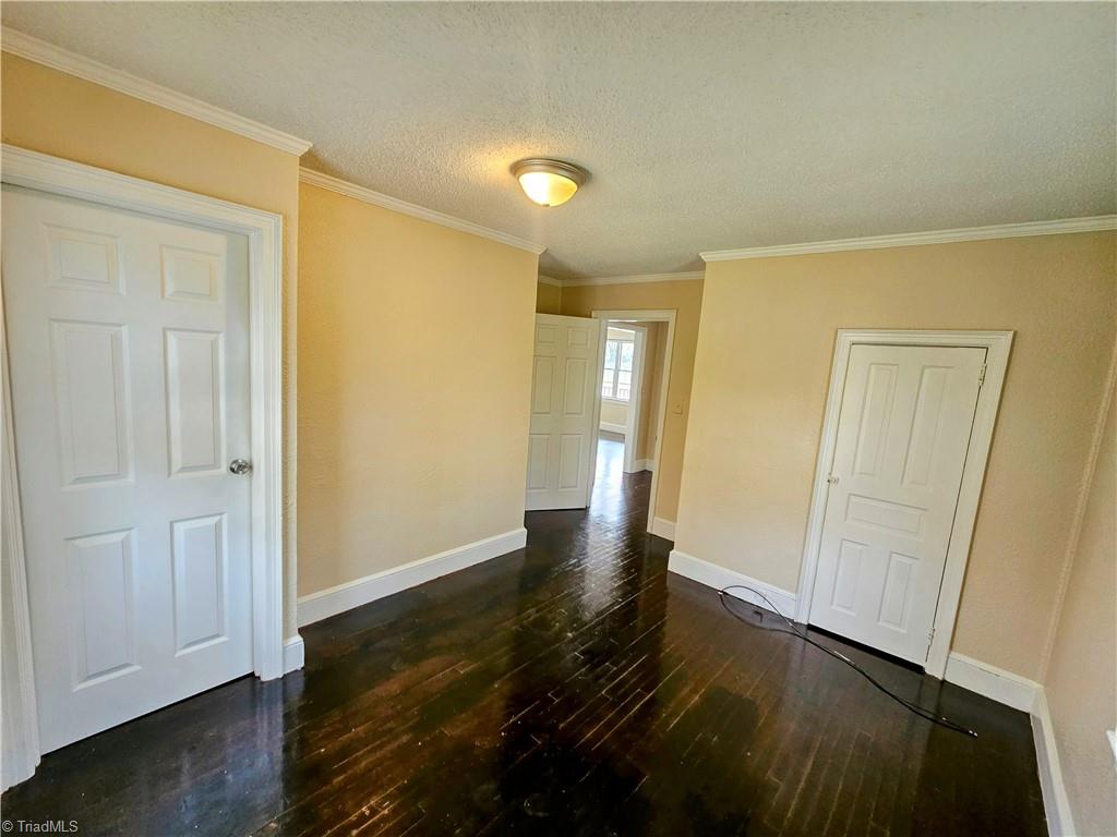 607 Arch Street High Point, NC 27260 - Photo 13 of 23 Bedroom 2 with wood floors - door to left leads to basement