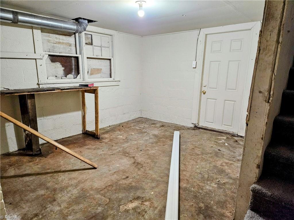 607 Arch Street High Point, NC 27260 - Photo 19 of 23 Workshop in utility basement - door leads to private backyard